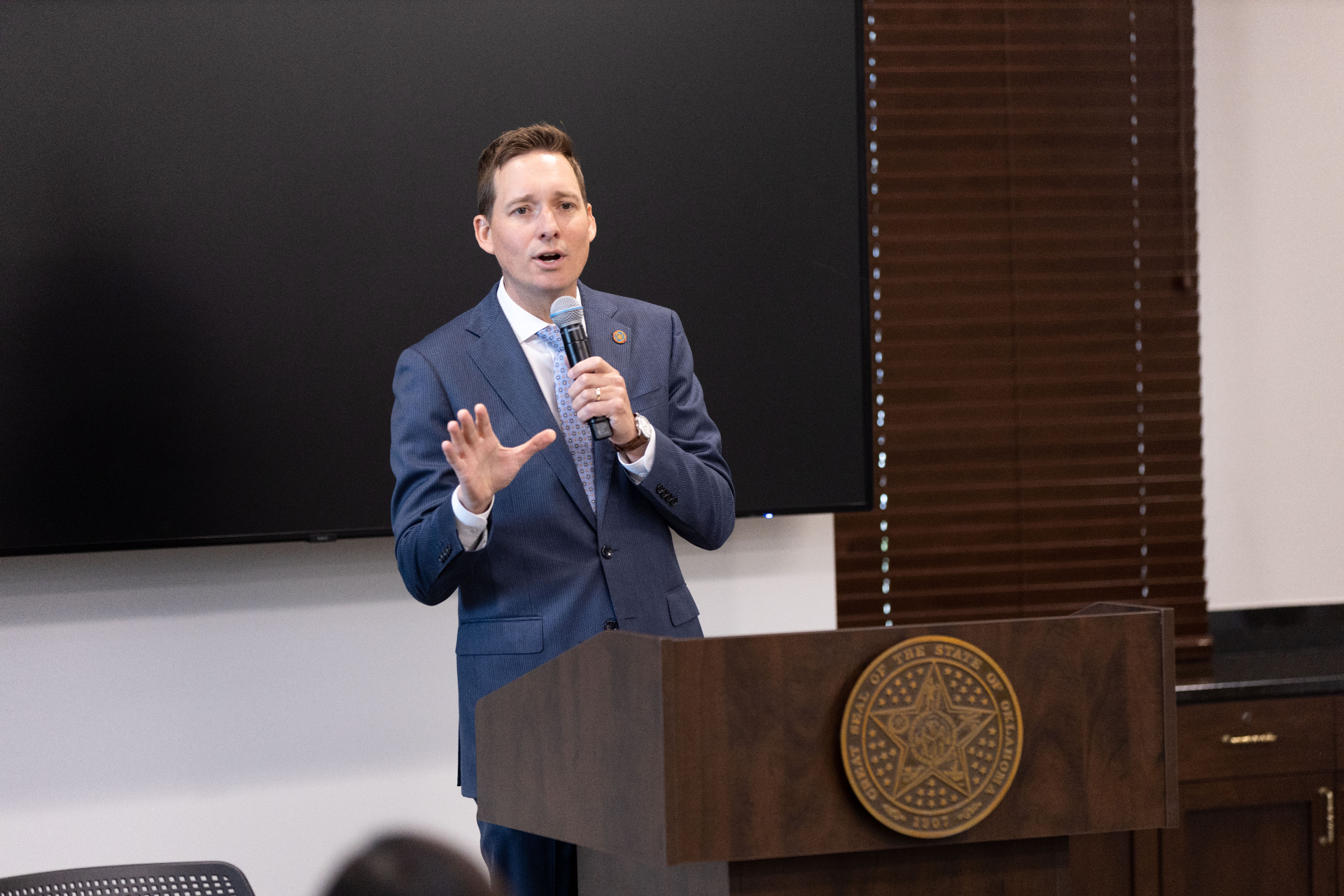 Speaker at YP Day at the Capitol with Oklahoma state seal