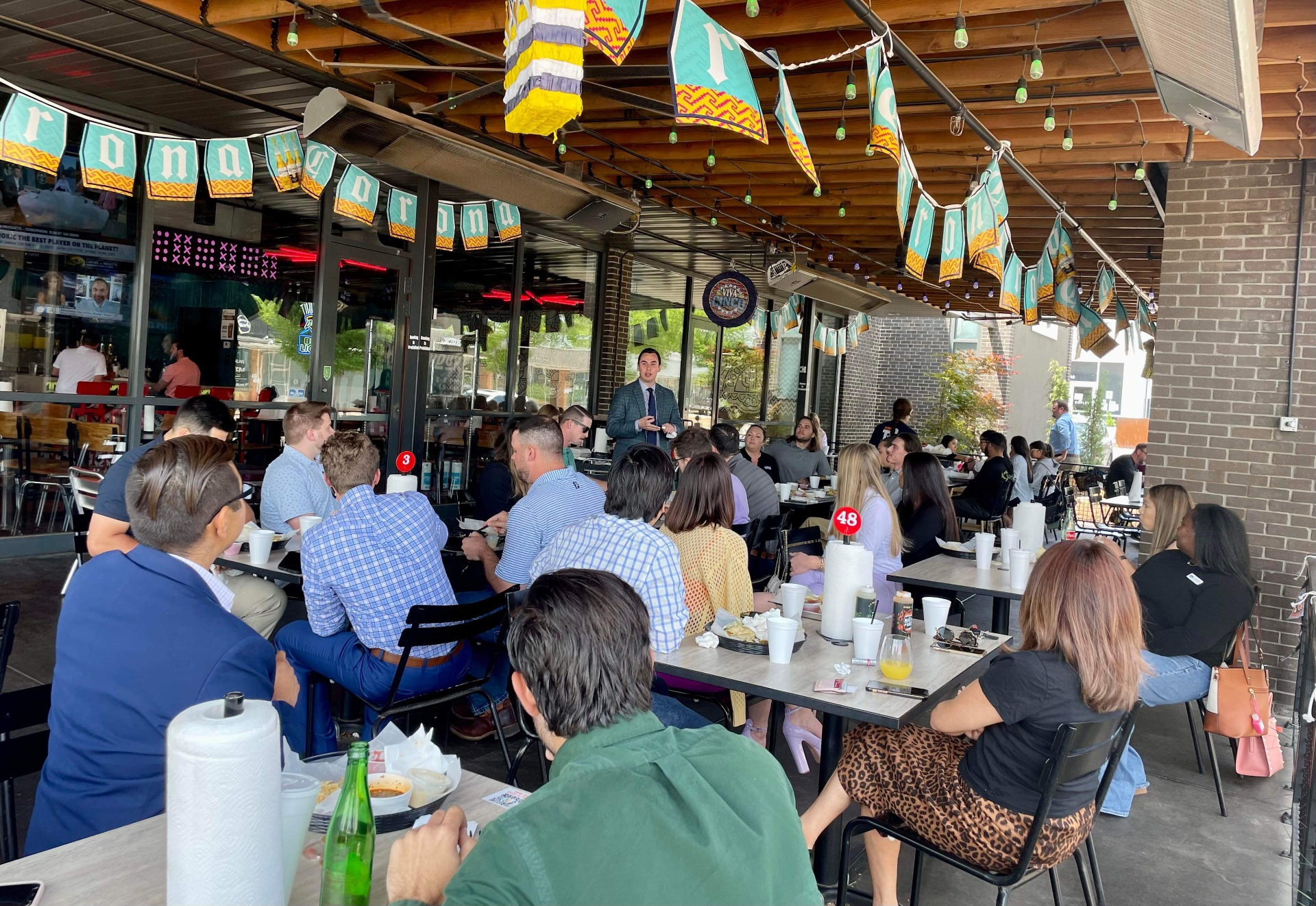 Speaker addressing OKCYP members at lunch event