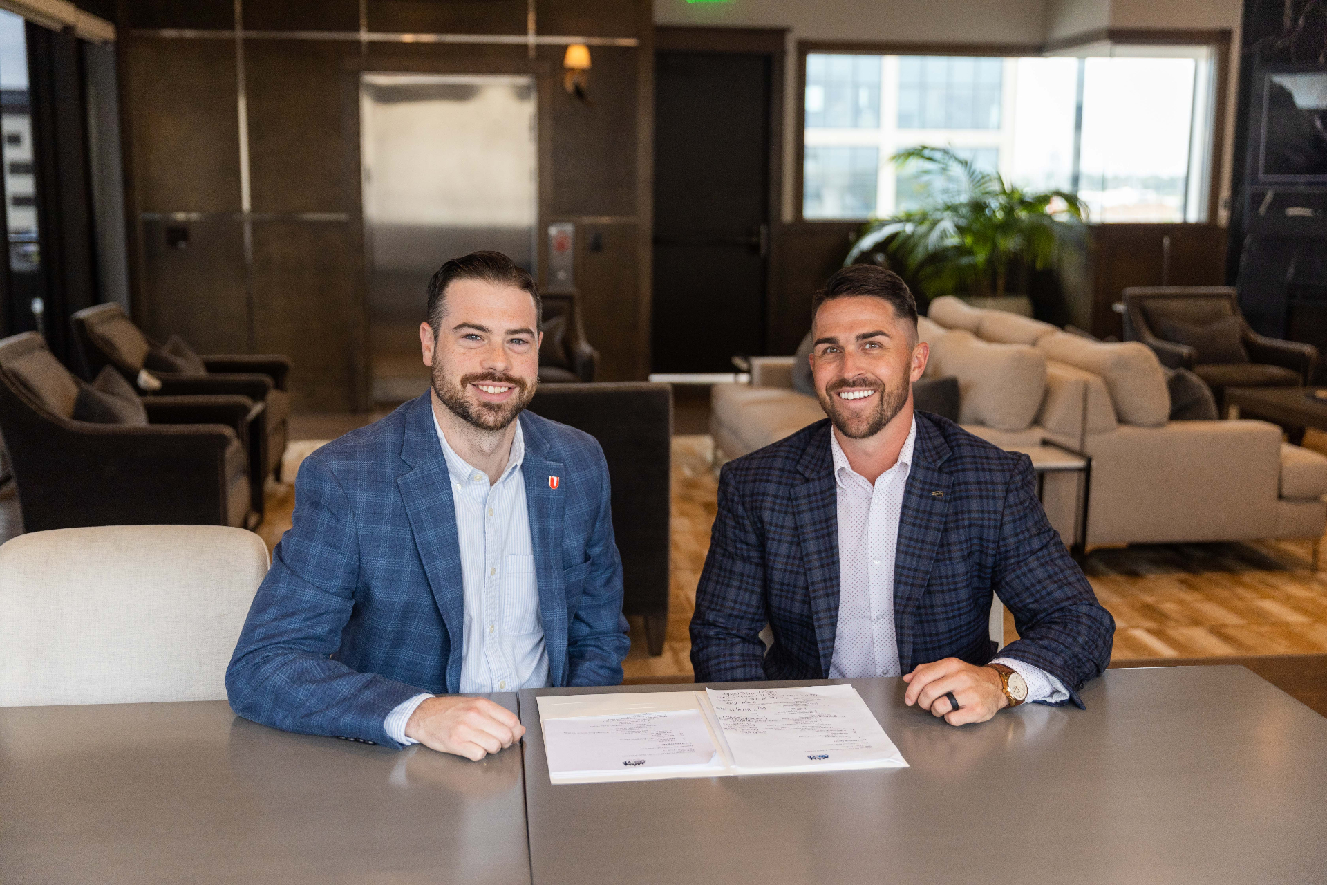 Two OKCYP men leaders seated at a table